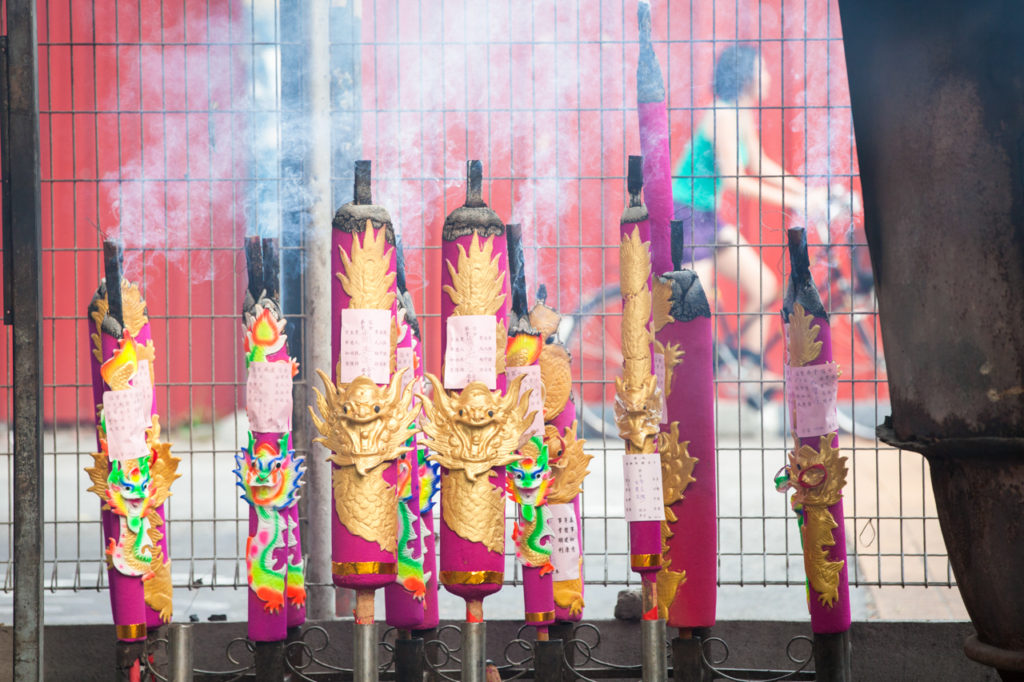 Burning incense at the Kuan Im Teng Temple