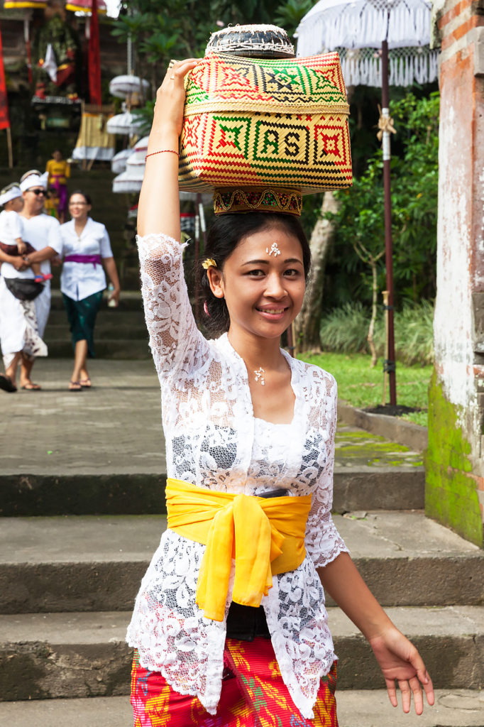 The young Balinese woman with a basket for offerings, Ubud, Bali, Indonesia