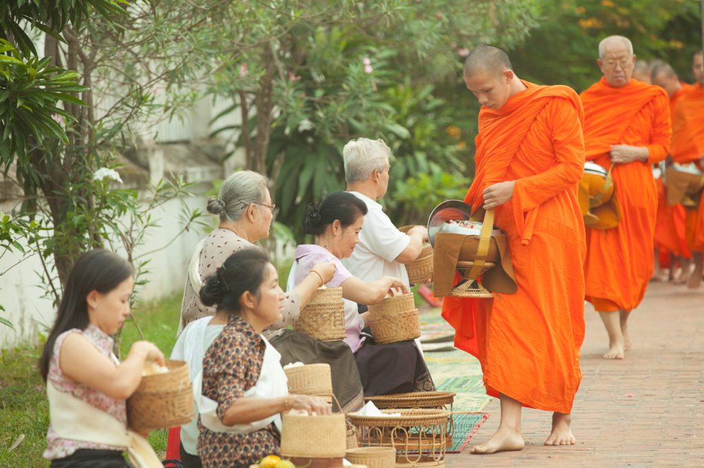 Lao people give alms to Buddhist monks, Luang Prabang, Laos