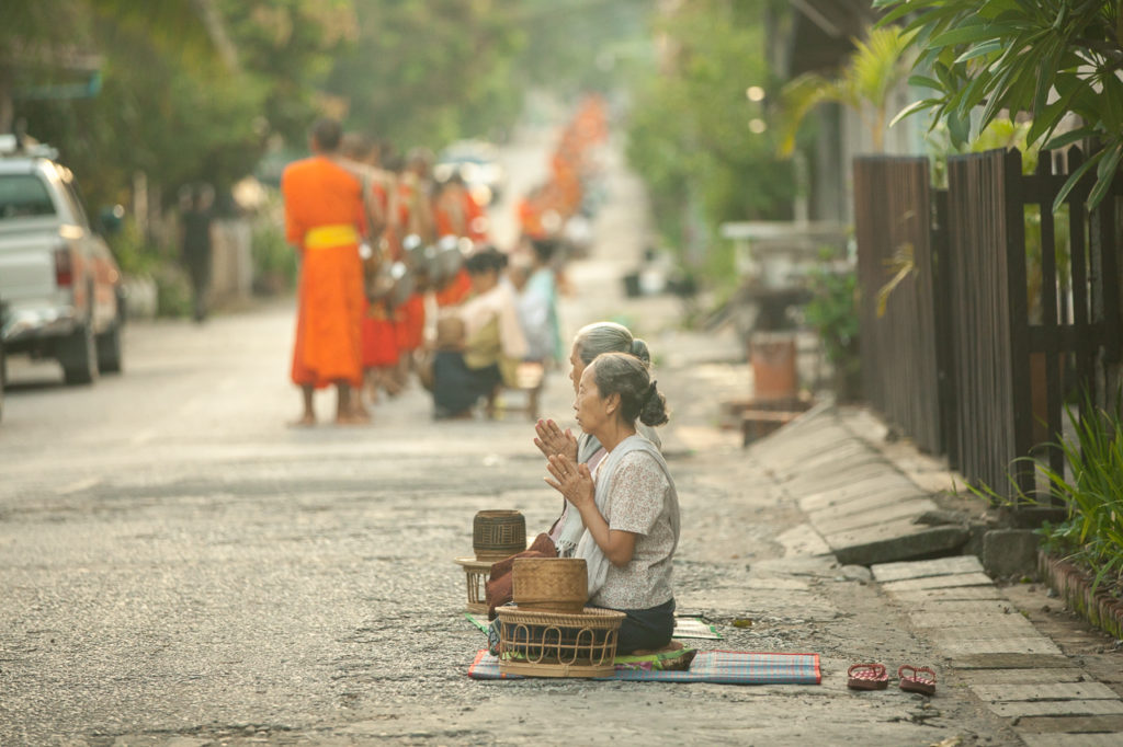 Women pray after the ceremony, Luang Prabang, Laos