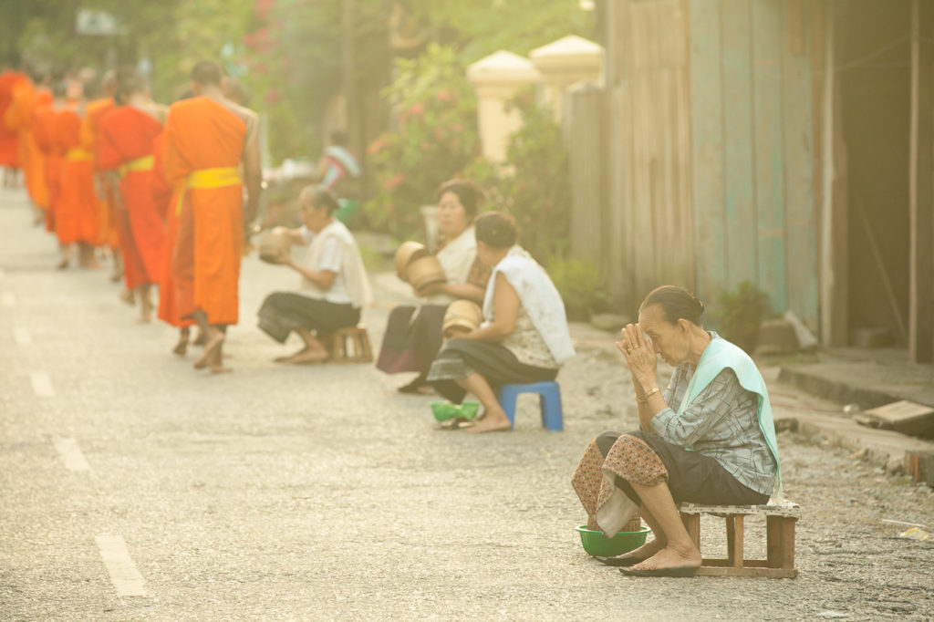 A woman prays after the ceremony, Luang Prabang, Laos