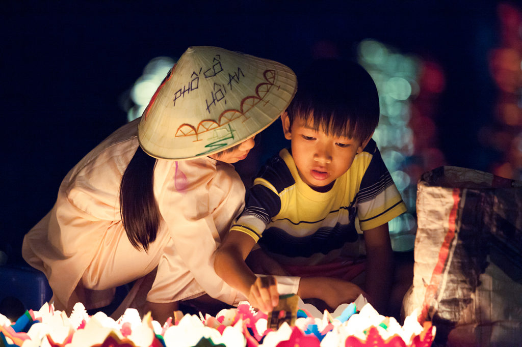 Hoi An, Vietnam: Kids sell candles during the Full Moon Festival